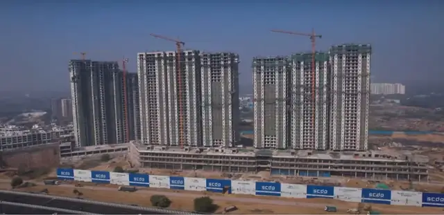 M3M Capital Walk – aerial construction view with the residential towers behind (actual photo)