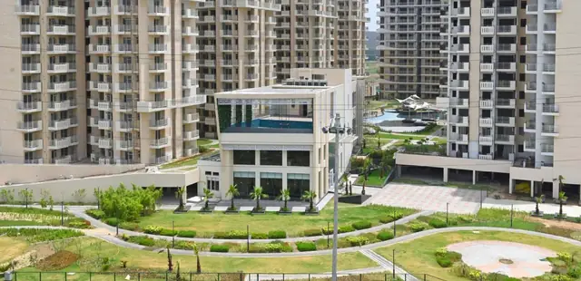 M3M Flora 68 – clubhouse and central lawns between the towers (actual photograph)