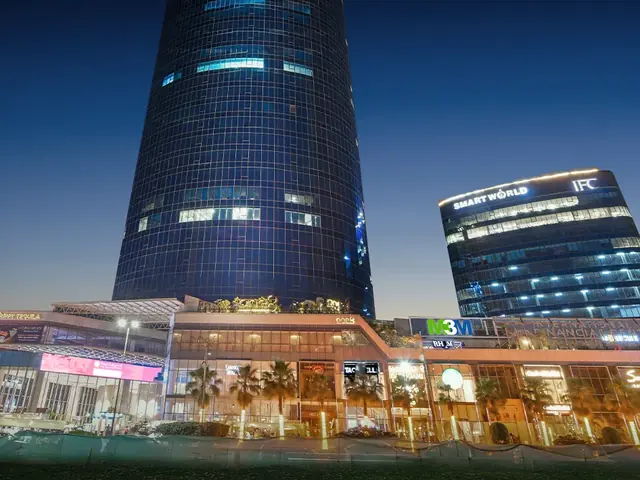 M3M IFC – both towers and the lit retail podium at night (actual photograph)