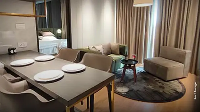 M3M My Den – dining and living area in a furnished unit (actual photograph)