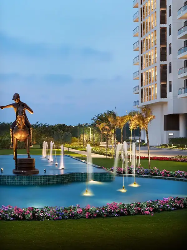 M3M Polo Suites – tower and polo-player fountain at dusk (actual photograph)