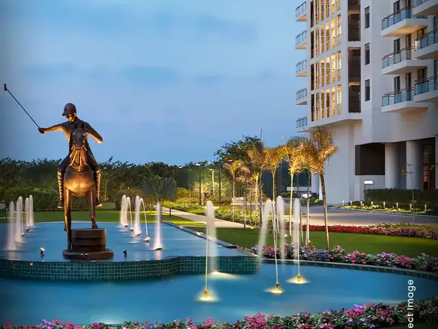 M3M Polo Suites – tower and polo-player fountain at dusk (actual photograph)