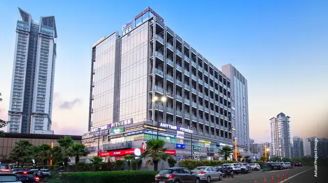 M3M Tee Point – retail frontage and upper floors at dusk (actual photograph)