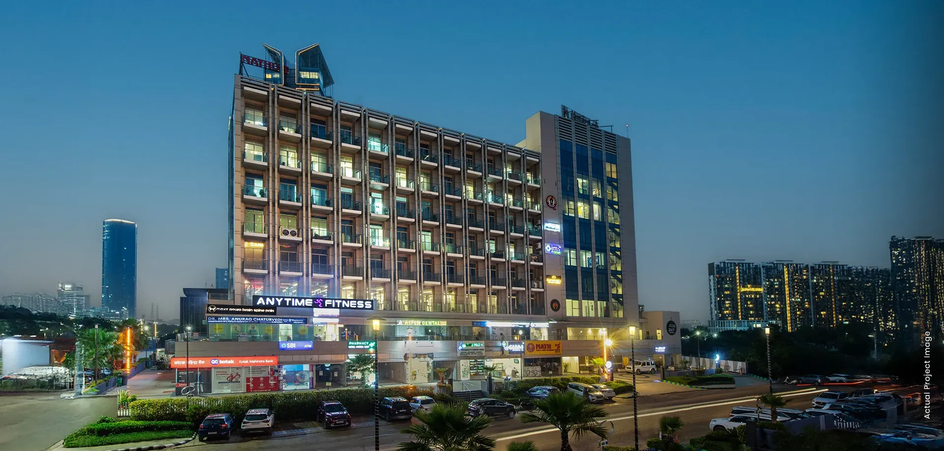 M3M Tee Point – illuminated retail-and-office block at dusk (actual photograph)